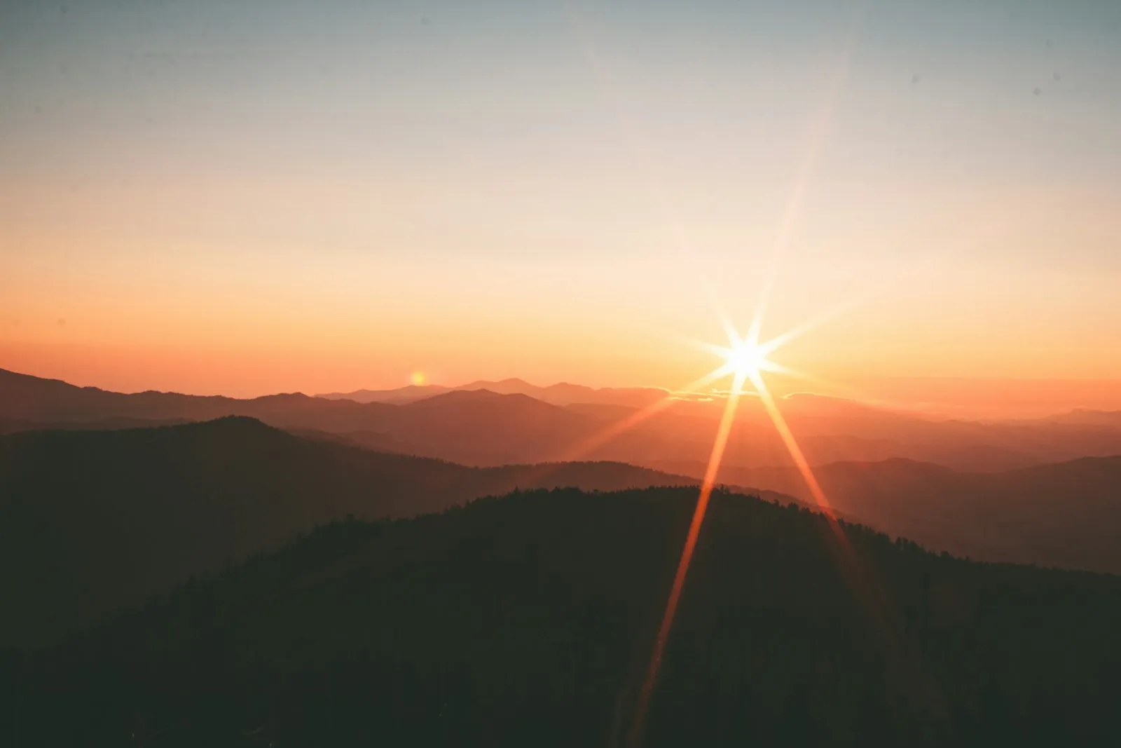 Sun setting over layered Australian ranges